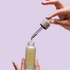 Exuviance CitraFirm Face Oil-dropper bottle in use