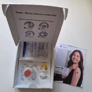 Tasso+ device including the box and other items needed to complete a blood test