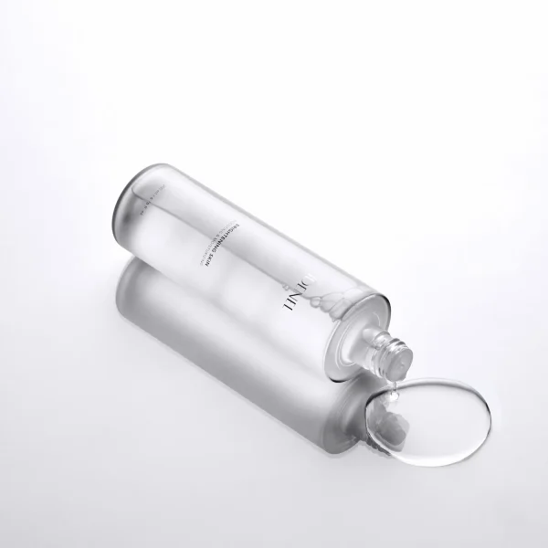 IDENEL Brightening-Skin showing liquid pouring from bottle